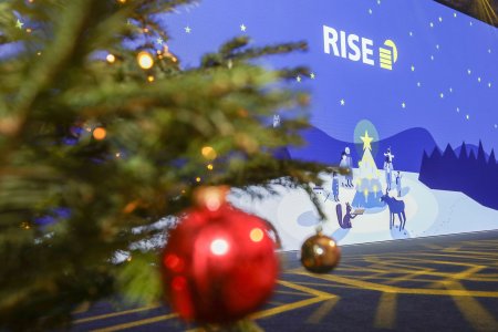 A picture of the screen with a Christmas tree and a Christmas tree bauble in the foreground (out of focus)